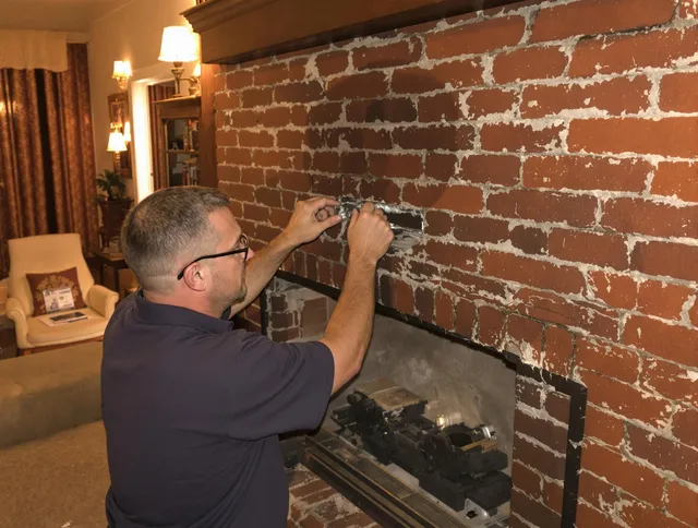 Strongsville Chimney Sweep expert fixing a fireplace in Strongsville, OH